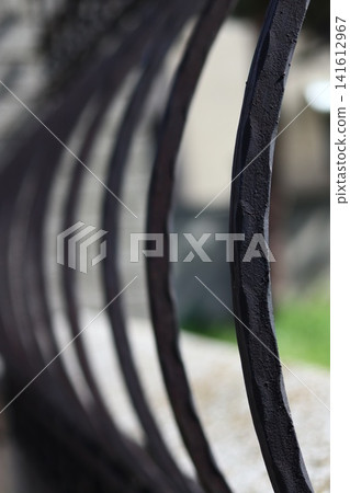 A fragment of the bars of a metal fence. A fragment of the bars of a metal fence. 141612967