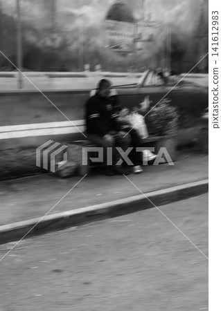 Homeless people relax on a bench. Homeless people relax on a bench. 141612983