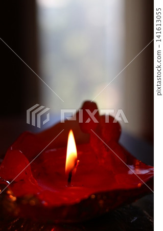 A burning candle in the form of a figurine. A burning candle in the form of a figurine. 141613055