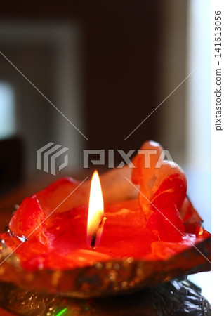 A burning candle in the form of a figurine. A burning candle in the form of a figurine. 141613056