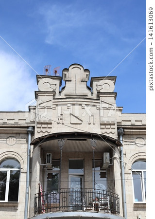 The facade of an old building with a balcony. The facade of an old building with a balcony. 141613069
