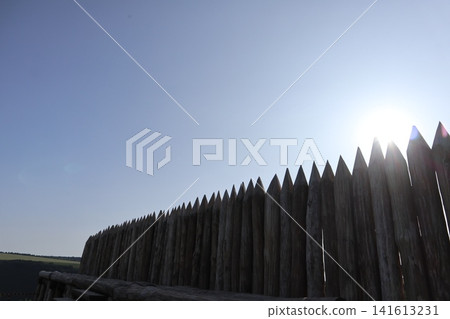Wooden log fence against the sky. Wooden log fence against the sky. 141613231