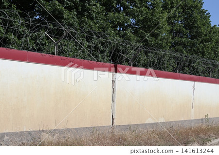 A stone fence with barbed wire. A stone fence with barbed wire. 141613244