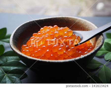 A chopstick holder with salmon roe in a Japanese-style dish A chopstick holder with salmon roe in a Japanese-style dish 141613424
