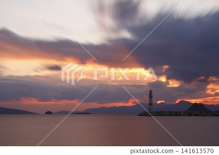 Seascape at sunshine. Lighthouse and sailings on the coast. Seaside town of Turgutreis and spectacular sunshine. Long Exposure shoot. tranquility scene. Seascape at sunshine. Lighthouse and sailings on the coast. Seaside town of Turgutreis and spectacular sunshine. Long Exposure shoot. tranquility scene. 141613570