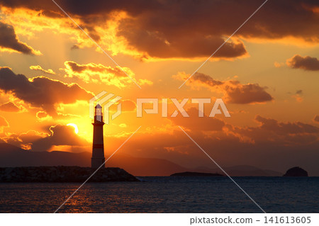 Seascape at sunshine. Lighthouse and sailings on the coast. Seaside town of Turgutreis and spectacular sunshine Seascape at sunshine. Lighthouse and sailings on the coast. Seaside town of Turgutreis and spectacular sunshine 141613605