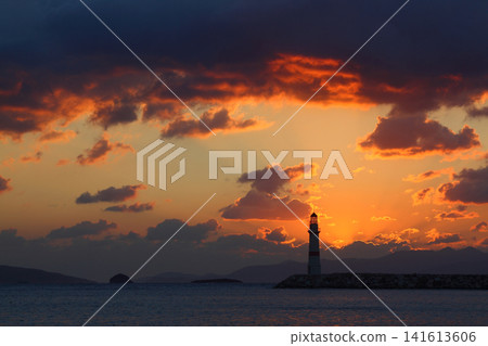 Seascape at sunshine. Lighthouse and sailings on the coast. Seaside town of Turgutreis and spectacular sunshine Seascape at sunshine. Lighthouse and sailings on the coast. Seaside town of Turgutreis and spectacular sunshine 141613606