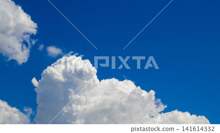 giant powerful white cumulus cloud occupies the lower corner of a bright blue clear sky giant powerful white cumulus cloud occupies the lower corner of a bright blue clear sky 141614332