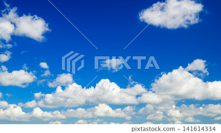 white cumulus clouds drift across the bright blue summer sky on a sunny day white cumulus clouds drift across the bright blue summer sky on a sunny day 141614334