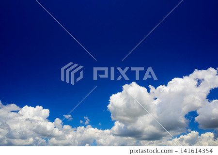 white fluffy clouds against a bright blue clear sky on a sunny clear day white fluffy clouds against a bright blue clear sky on a sunny clear day 141614354