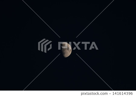 A crescent moon, its crater visible, floating alone in the dark night sky. A crescent moon, its crater visible, floating alone in the dark night sky. 141614396