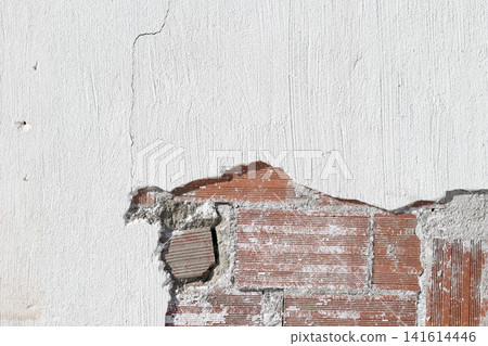 background of a damaged white plastered wall revealing red brick masonry structure background of a damaged white plastered wall revealing red brick masonry structure 141614446