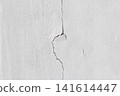 background texture of a cracked white concrete wall with damaged cement surface 141614447