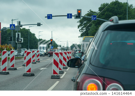 Traffic Congestion at Urban Roadworks with Temporary Lane Closures and Red Traffic Signal Ahead Scene Traffic Congestion at Urban Roadworks with Temporary Lane Closures and Red Traffic Signal Ahead Scene 141614464