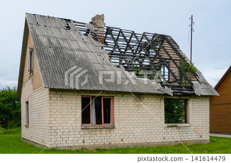 Fire Damaged Abandoned Brick House with Collapsed Roof Structure and Severe Structural Damage Exterior Fire Damaged Abandoned Brick House with Collapsed Roof Structure and Severe Structural Damage Exterior 141614479