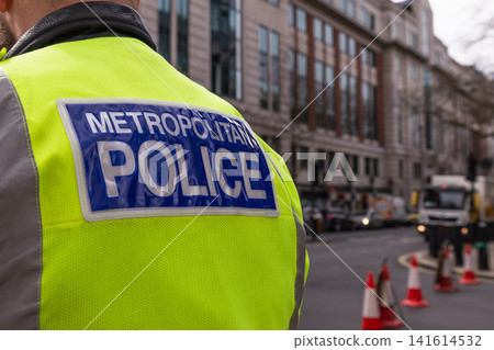 Metropolitan Police officer on duty on London city street Metropolitan Police officer on duty on London city street 141614532