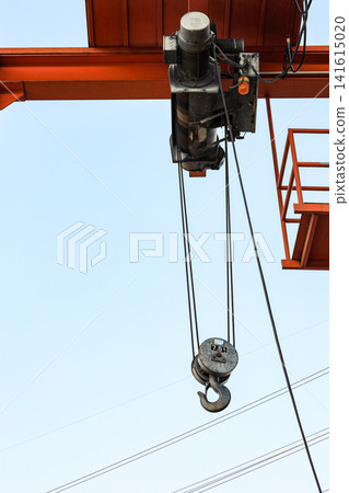 Red 7.5 Tons Industrial hook with chains or chain hoist on duty at construction site. Red 7.5 Tons Industrial hook with chains or chain hoist on duty at construction site. 141615020