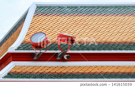 Modern LED spotlights installed on The edge of the roof of the place to illuminate outdoor area. Modern LED spotlights installed on The edge of the roof of the place to illuminate outdoor area. 141615039