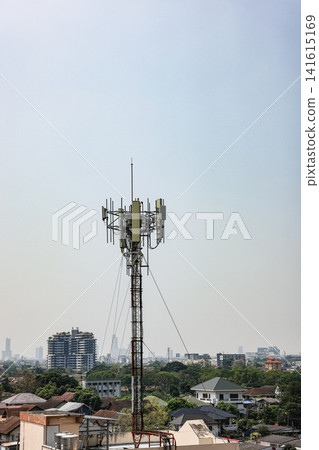 Close up equipment section of Wireless Communication Antenna pole, Mobile phone mast antenna pole on top of dilapidated building Close up equipment section of Wireless Communication Antenna pole, Mobile phone mast antenna pole on top of dilapidated building 141615169