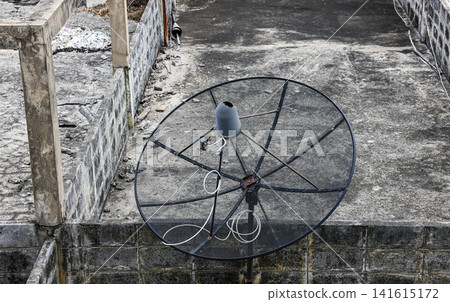Abandon or Broken antenna communication satellite dish on top of old building. Abandon or Broken antenna communication satellite dish on top of old building. 141615172