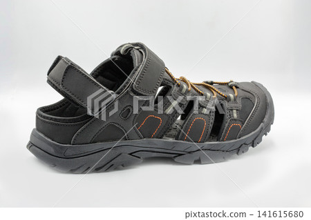 Mens black sporty trekking sandals active footwear closeup on white. Mens black sporty trekking sandals active footwear closeup on white. 141615680