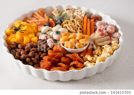 Halloween candy platter with spooky sweets on white background Halloween candy platter with spooky sweets on white background 141615703