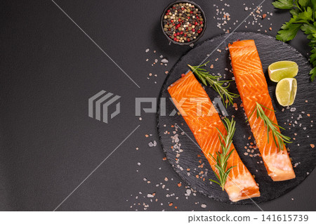 Fresh raw salmon fillets preparing with herbs and lime Fresh raw salmon fillets preparing with herbs and lime 141615739