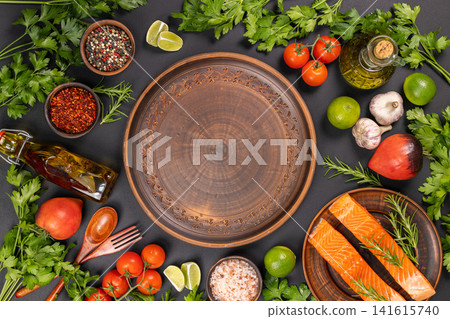 Fresh salmon fillets with herbs and spices ready for cooking Fresh salmon fillets with herbs and spices ready for cooking 141615740