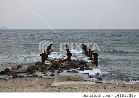 old, rusty abandoned and dismantled pier. sky space is empty. suitable for writing. old, rusty abandoned and dismantled pier. sky space is empty. suitable for writing. 141615889