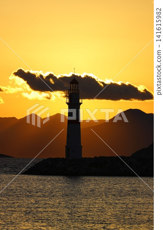Seascape at sunshine. Lighthouse and sailings on the coast. Seaside town of Turgutreis and spectacular sunshine Seascape at sunshine. Lighthouse and sailings on the coast. Seaside town of Turgutreis and spectacular sunshine 141615982
