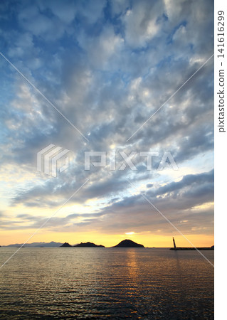 Seascape at sunshine. Lighthouse and sailings on the coast. Seaside town of Turgutreis and spectacular sunshine Seascape at sunshine. Lighthouse and sailings on the coast. Seaside town of Turgutreis and spectacular sunshine 141616299