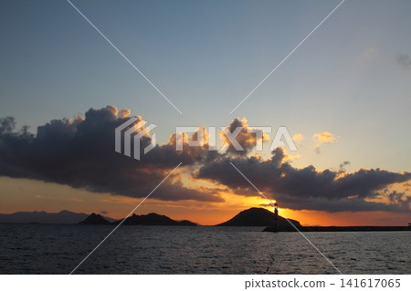 Seascape at sunshine. Lighthouse and sailings on the coast. Seaside town of Turgutreis and spectacular sunshine Seascape at sunshine. Lighthouse and sailings on the coast. Seaside town of Turgutreis and spectacular sunshine 141617065