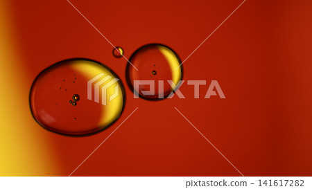 Oil droplets and bubbles suspended in red and yellow liquid Oil droplets and bubbles suspended in red and yellow liquid 141617282
