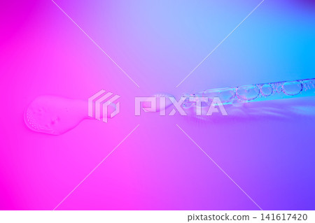 Cosmetic serum liquid and dropper on vibrant gradient background Cosmetic serum liquid and dropper on vibrant gradient background 141617420