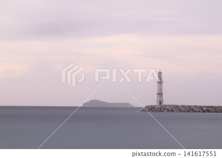 Seascape at sunshine. Lighthouse and sailings on the coast. Seaside town of Turgutreis and spectacular sunshine Seascape at sunshine. Lighthouse and sailings on the coast. Seaside town of Turgutreis and spectacular sunshine 141617551