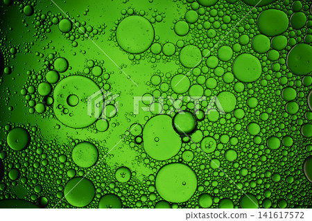 Green oil droplets floating in water creating a beautiful abstract texture Green oil droplets floating in water creating a beautiful abstract texture 141617572