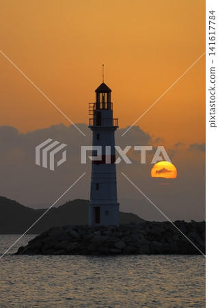 Seascape at sunshine. Lighthouse and sailings on the coast. Seaside town of Turgutreis and spectacular sunshine 141617784