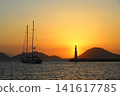 Seascape at sunshine. Lighthouse and sailings on the coast. Seaside town of Turgutreis and spectacular sunshine 141617785