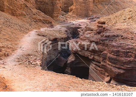 Desert hiking trail along Red canyon slot gorge near Eilat Israel (black path) Desert hiking trail along Red canyon slot gorge near Eilat Israel (black path) 141618107