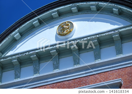 The Japan Maritime Self-Defense Force's 1st Technical School in Etajima, Hiroshima Prefecture: An anchor emblem shines brightly at the entrance to the officer candidate school building. The Japan Maritime Self-Defense Force's 1st Technical School in Etajima, Hiroshima Prefecture: An anchor emblem shines brightly at the entrance to the officer candidate school building. 141618334