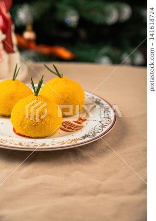 Healthy New Year mochi desserts in mandarin shape on festive plate with copy space for text dairy free lactose low calorie natural ingredients holiday Healthy New Year mochi desserts in mandarin shape on festive plate with copy space for text dairy free lactose low calorie natural ingredients holiday 141618724