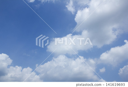 It is a blue sky with fluffy clouds. It is a blue sky with fluffy clouds. 141619693