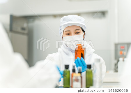Staff wearing clean suits developing drugs at a pharmaceutical factory or pharmaceutical company Staff wearing clean suits developing drugs at a pharmaceutical factory or pharmaceutical company 141620036