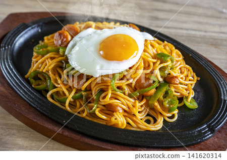 Classic Neapolitan spaghetti served piping hot on a sizzling plate. Classic Neapolitan spaghetti served piping hot on a sizzling plate. 141620314