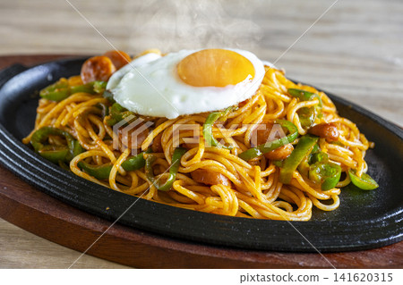 Classic Neapolitan spaghetti served piping hot on a sizzling plate. Classic Neapolitan spaghetti served piping hot on a sizzling plate. 141620315