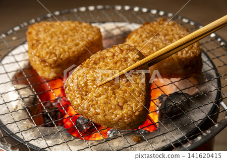 Grill rice balls over charcoal. Grill rice balls over charcoal. 141620415