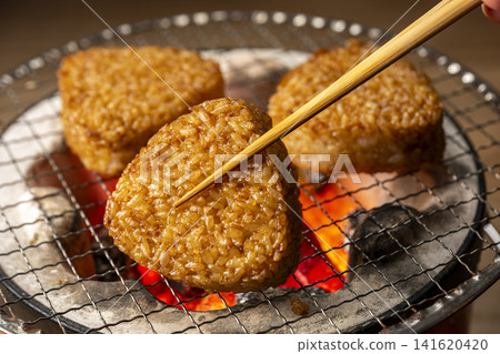 Grill rice balls over charcoal. Grill rice balls over charcoal. 141620420