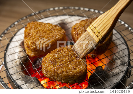 Grill rice balls over charcoal. Grill rice balls over charcoal. 141620429