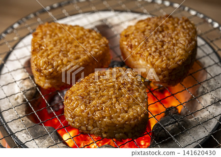 Grill rice balls over charcoal. Grill rice balls over charcoal. 141620430