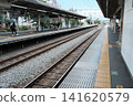 A monochrome snapshot of people waiting for a train on the platform at Higashi-Fushimi Station on the Seibu Shinjuku Line, in the suburbs of Tokyo. 141620579